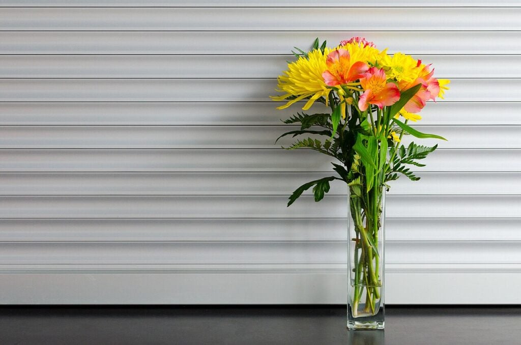A mixed bouquet of fresh flowers in a glass vase (stock photo)